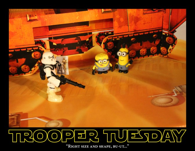 Sandtrooper stands with a photo of R2-D2 and C3-PO while looking at two minions.