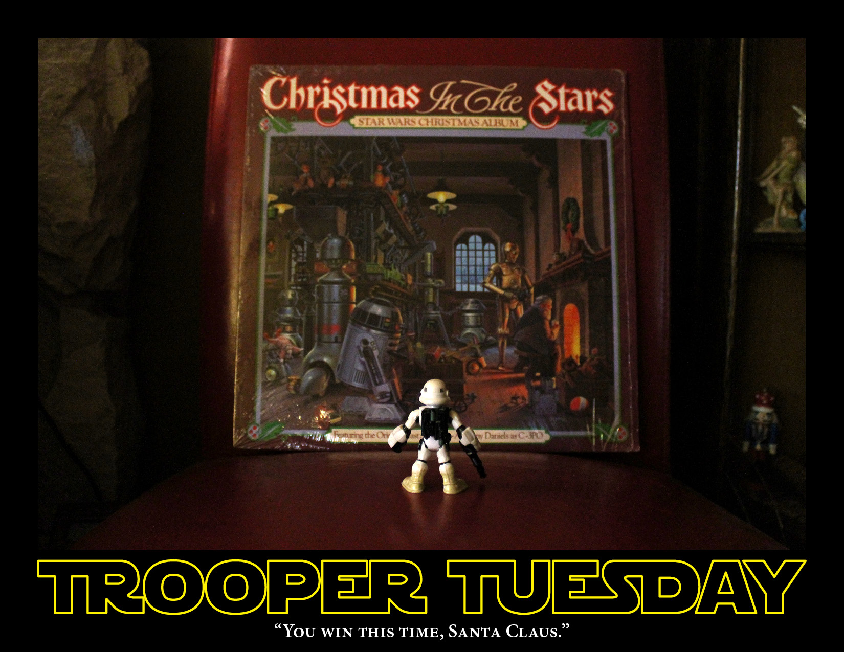 Sandy the Sandtrooper, looks at a Star Wars Christmas album cover.