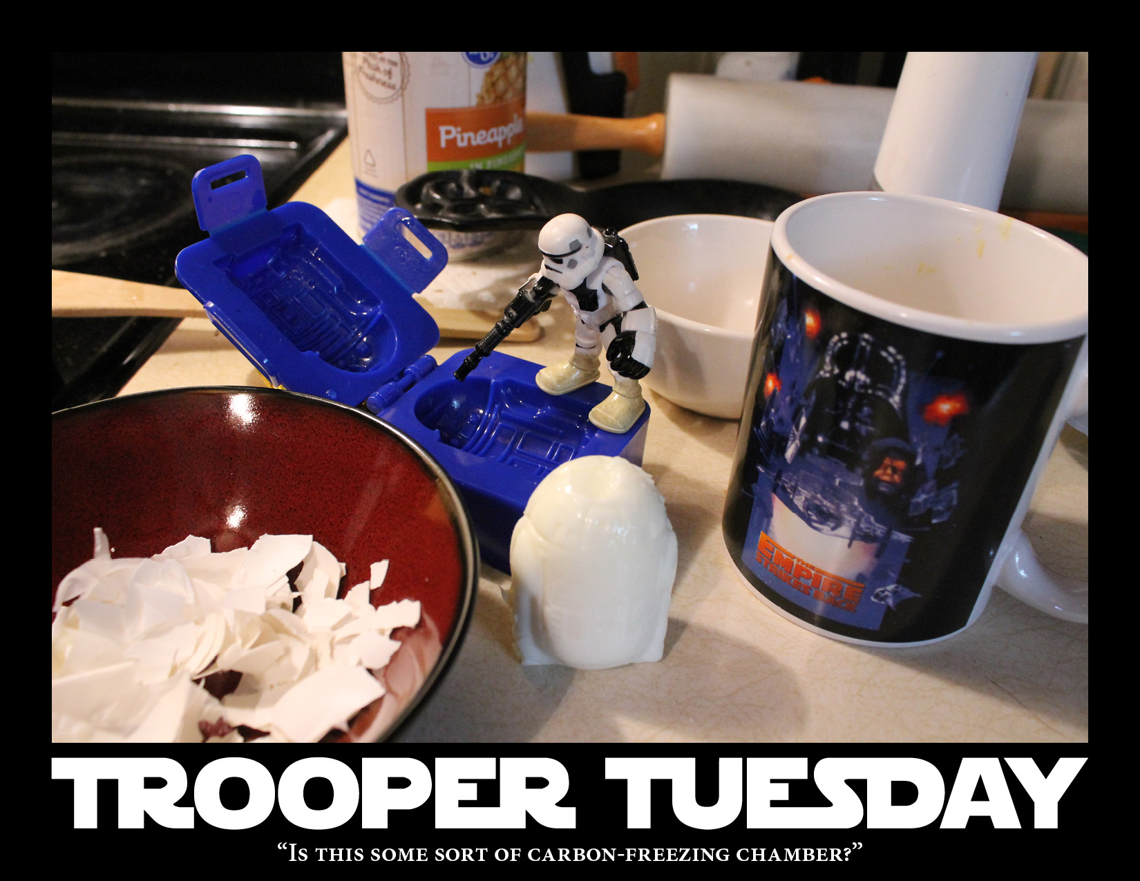 Stormtrooper examines an egg mold shaped like R2-D2.