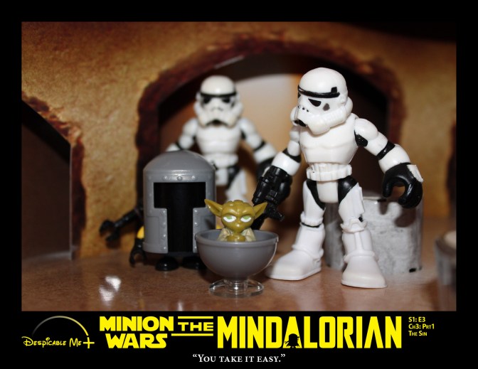 Two Stormtroopers escort the Mindalorian and baby Yoda.