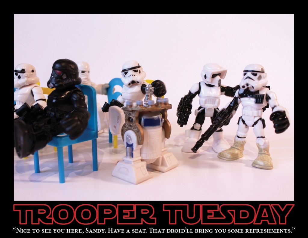 Stormtroopers gather together in a support meeting. R2-D2 serves refreshments.